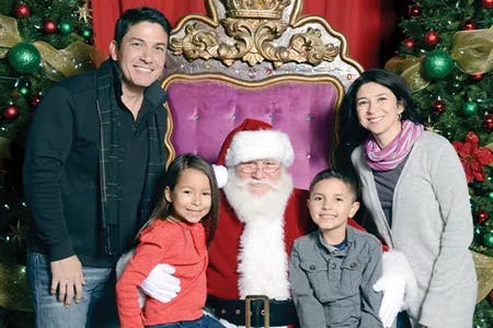 Family of four pose with Santa Clause