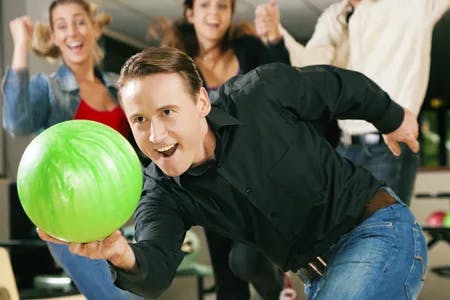 Man bowling with a green ball