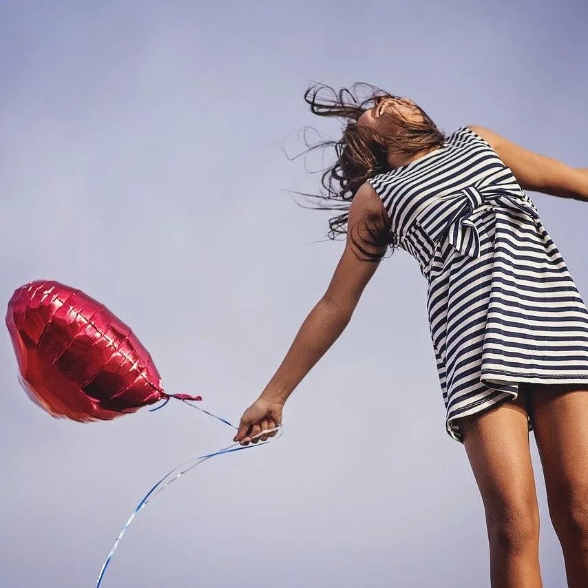 woman with a heart balloon